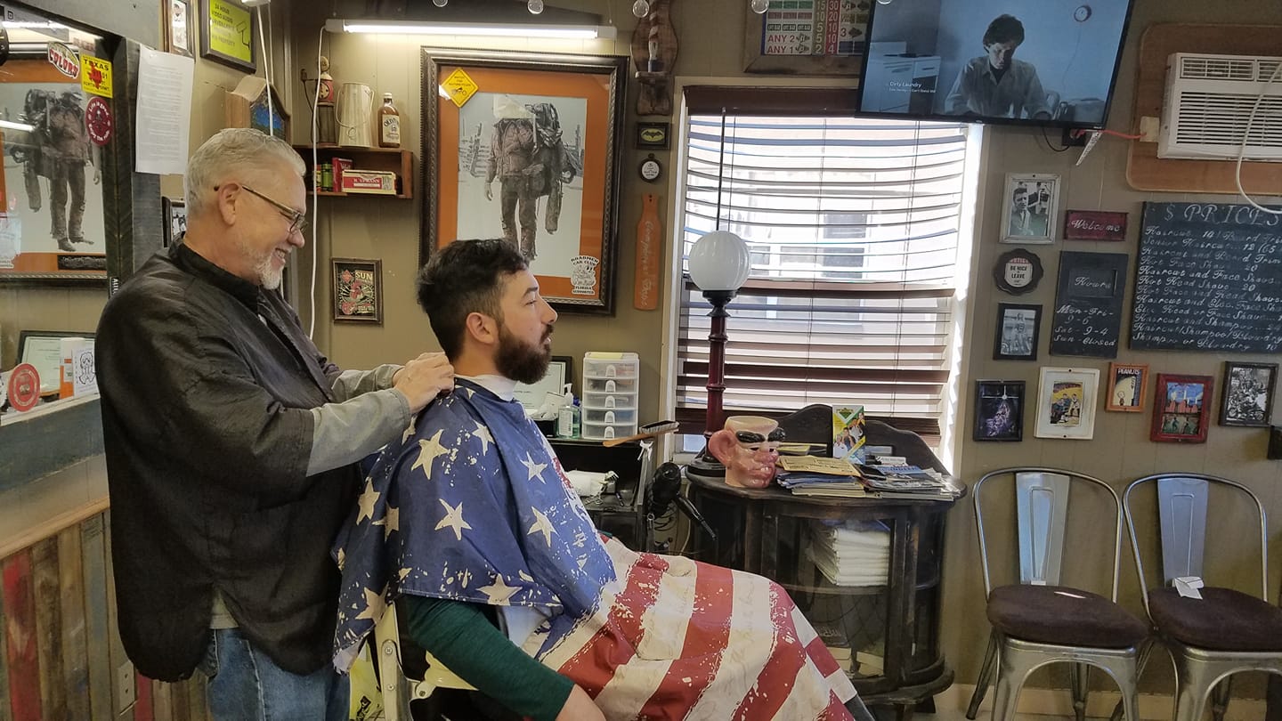 A barber at work inside Old Tyme Barber Shoppe